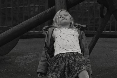Portrait of cute girl leaning outdoors