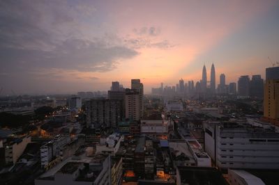 Cityscape against sky during sunset