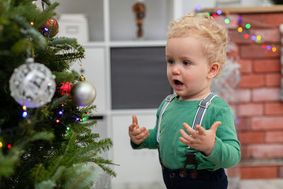 Portrait of cute girl decorating christmas tree