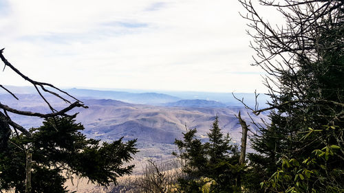 Scenic view of mountains against cloudy sky