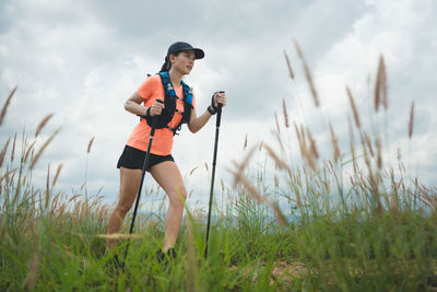 Full length of young woman standing on field