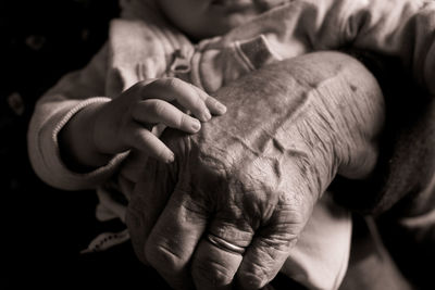 Close-up of grandparent carrying grandchild