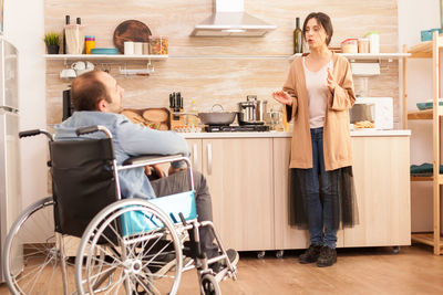 Woman sitting in kitchen at home