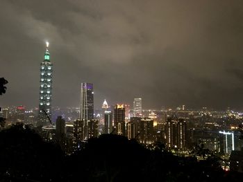 Illuminated modern buildings in city of taipei against sky at night