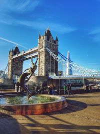 Bridge over river with city in background