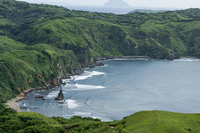 High angle view of land and sea against mountains