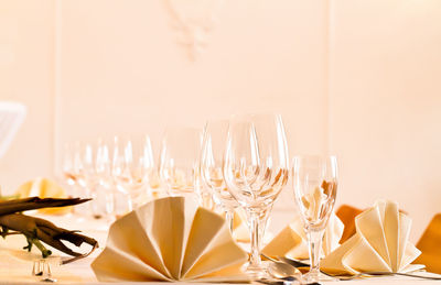 Close-up of wineglasses with napkins on dining table