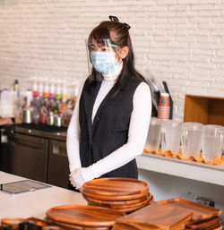 Coffee shop business owner wearing surgical mask. confident business woman