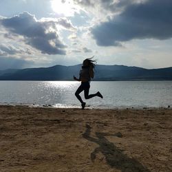 Full length of man on beach against sky