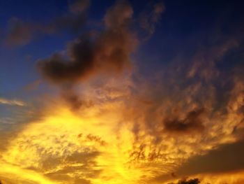 Low angle view of cloudy sky at sunset