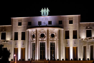 Low angle view of illuminated building at night