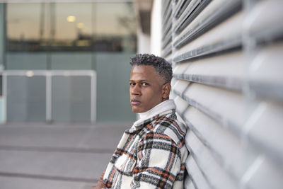 Side view portrait of a man with afro hairstyle looking at camera person