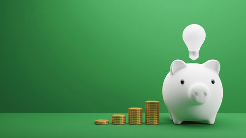 Close-up of piggy bank against blue background