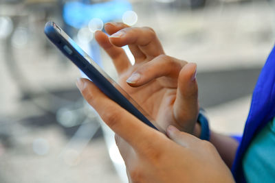 Midsection of man using mobile phone