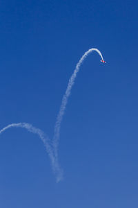 Low angle view of airplane flying against sky