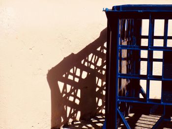 Shadow of railing on wall of building
