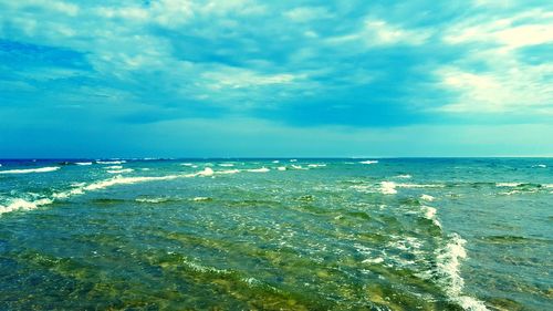 Scenic view of sea against cloudy sky