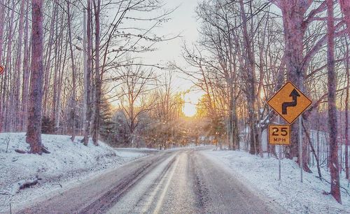 Road amidst bare trees during winter