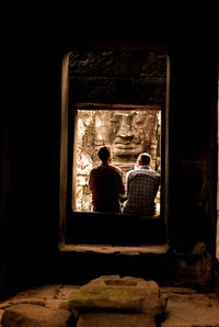 Full length of woman sitting on bench