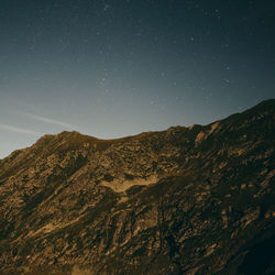 Scenic view of mountains against clear sky at night