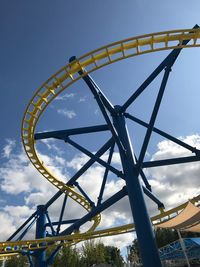 Low angle view of rollercoaster against sky