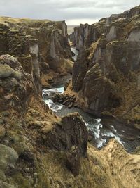 Rock formations by sea against sky