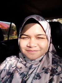 Portrait of smiling woman in car