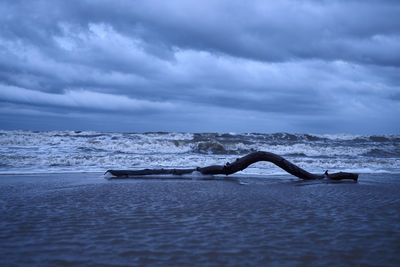 View of calm sea against cloudy sky