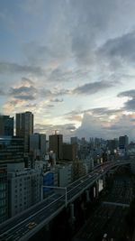 Cityscape against cloudy sky