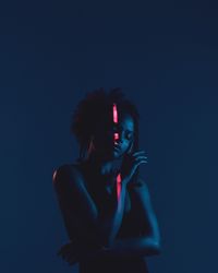 Woman in dark against black background