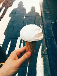 Close-up of hand holding ice cream cone