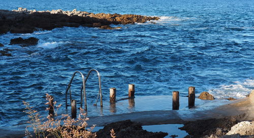 Ladder on rock formation in sea