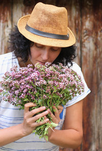 Midsection of woman holding flowers