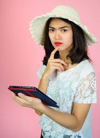 Portrait of beautiful young woman using smart phone