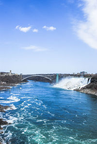 View of bridge over river against blue sky