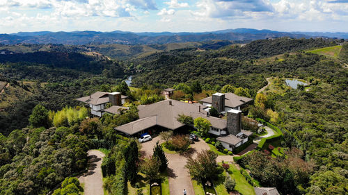 High angle view of houses and trees against sky