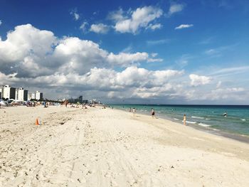 View of beach against cloudy sky