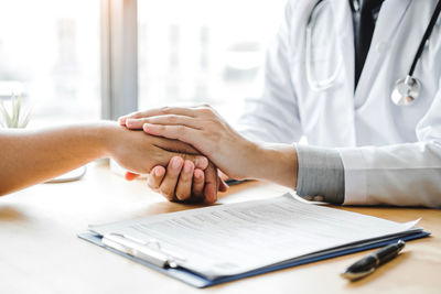 Midsection of couple in hands