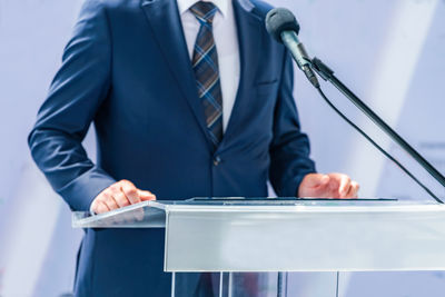 Midsection of businessman holding book