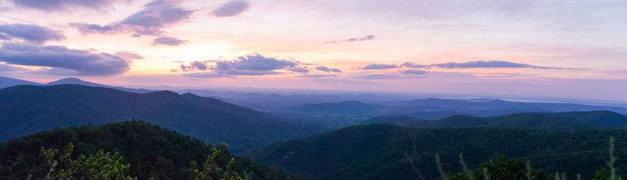 Scenic view of mountains against sky at sunset