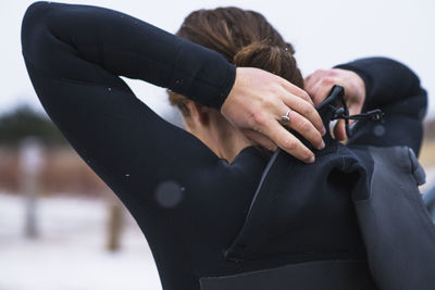 Young woman preparing for winter surfing in snow