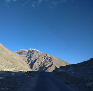 Scenic view of snowcapped mountains against clear blue sky