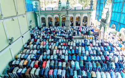 High angle view of people praying in mosque