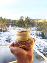 Close-up of hand holding ice cream cone