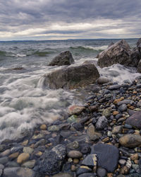 Rocks in sea against sky