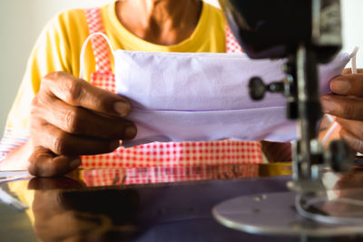 Midsection of woman working on table