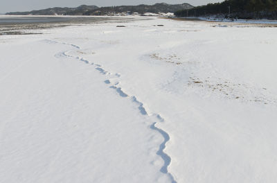 Scenic view of beach against sky during winter