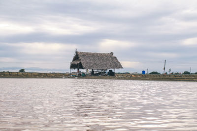 Scenic view of lake by building against sky