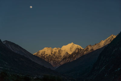 Scenic view of mountains against clear sky at night