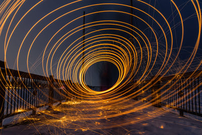 Light trails on spiral staircase at night